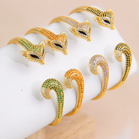Gold-plated adjustable bangle bracelets in green, orange, purple, and black