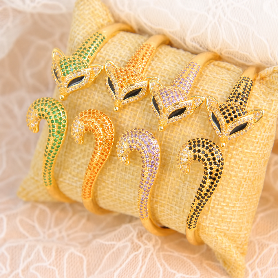 Four adjustable bangle bracelet colors on a display cushion