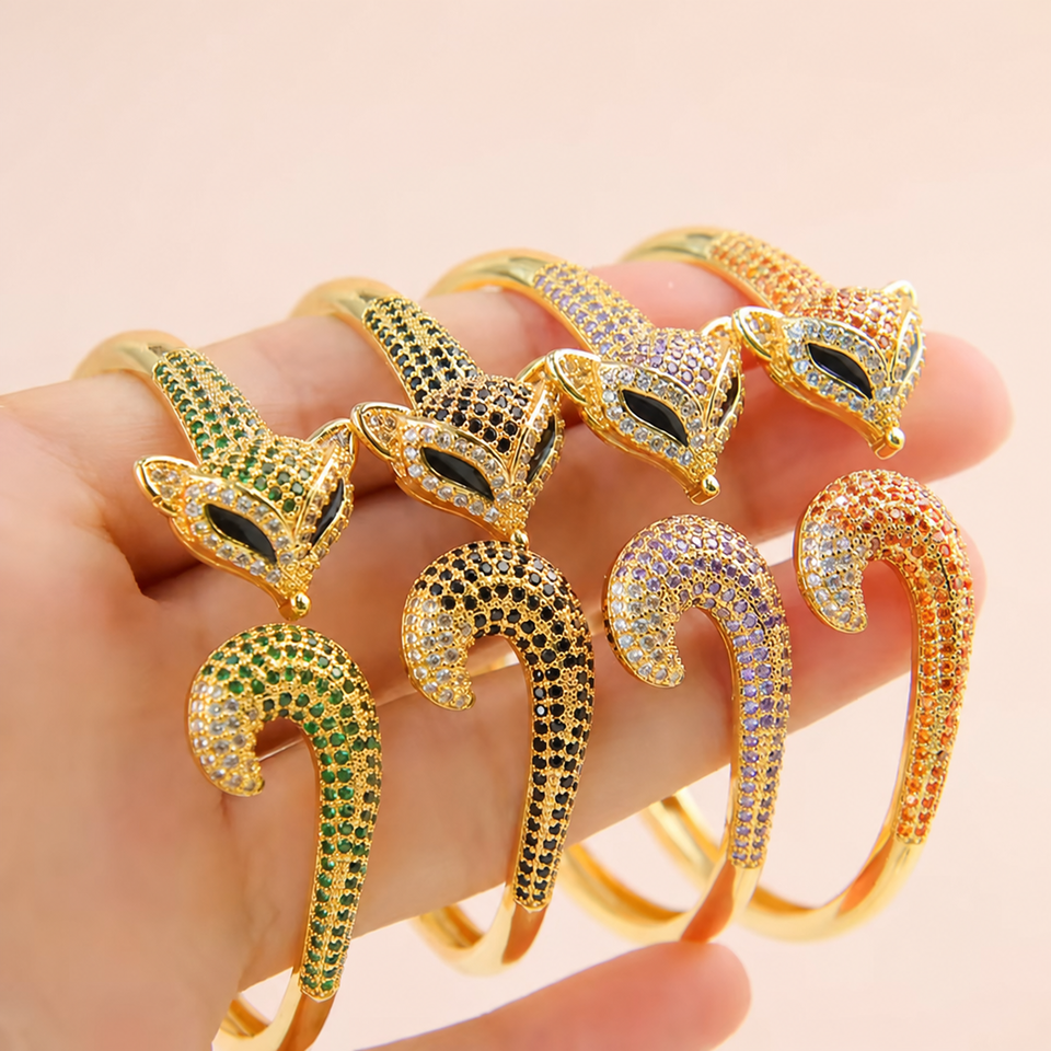 Four adjustable bangle bracelet colors held in hand