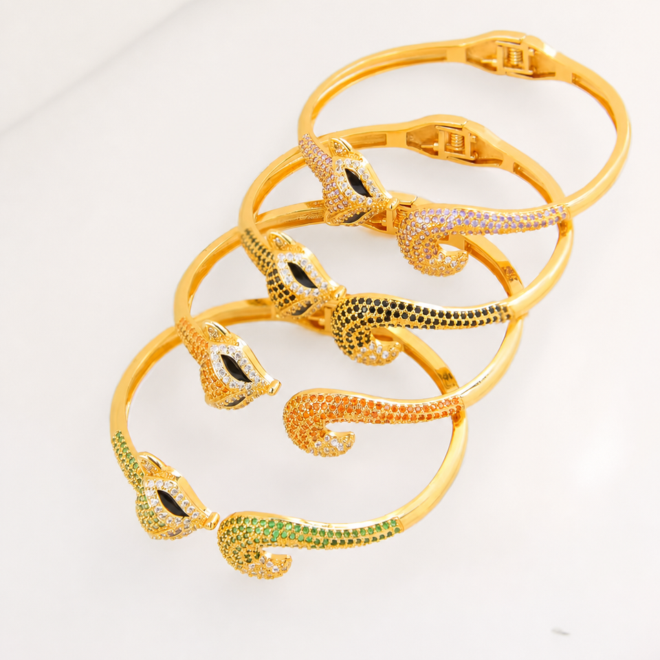 Gold-plated adjustable bangle bracelets laid flat in four colors