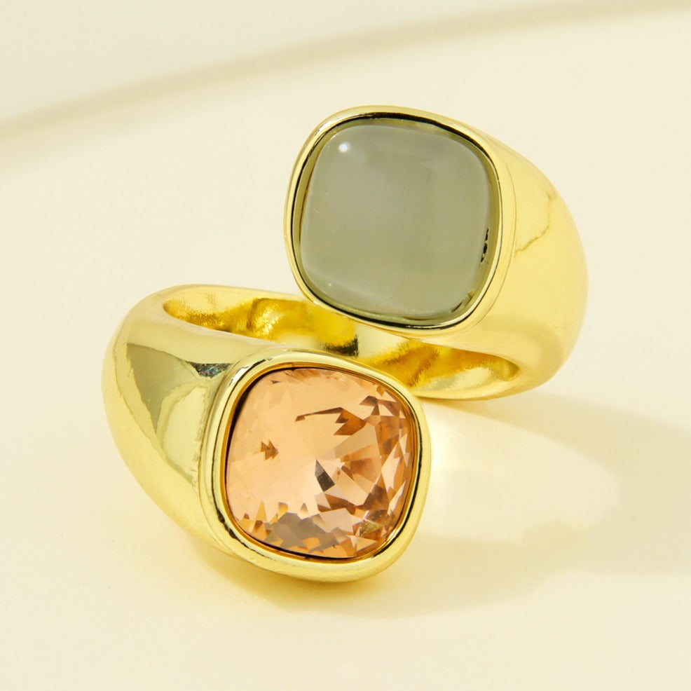 Gold-plated statement ring with grey-green and peach-colored square accents