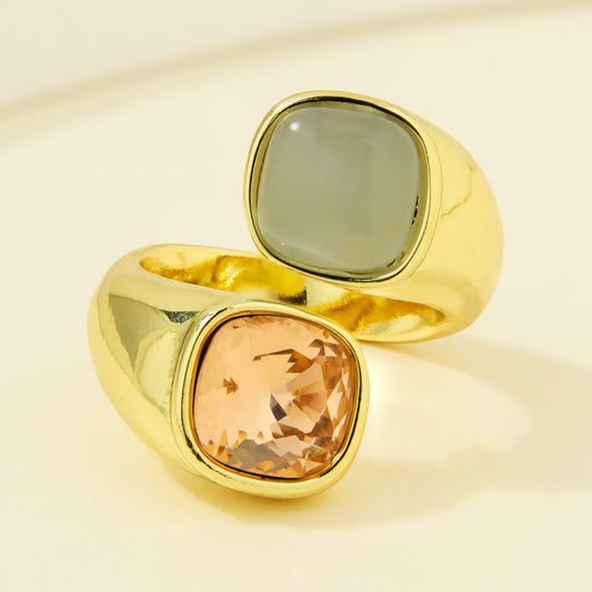 Gold-plated statement ring with grey-green and peach-colored square accents