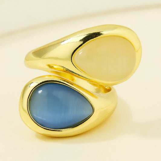 Gold-plated statement ring with cream and blue teardrop accents